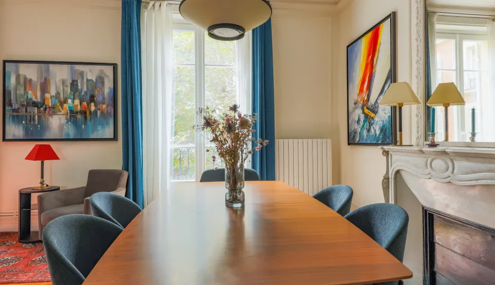 Salle à manger élégante et lumineuse, design moderne et touches artistiques. Un espace raffiné avec cheminée pour propriété de luxe.