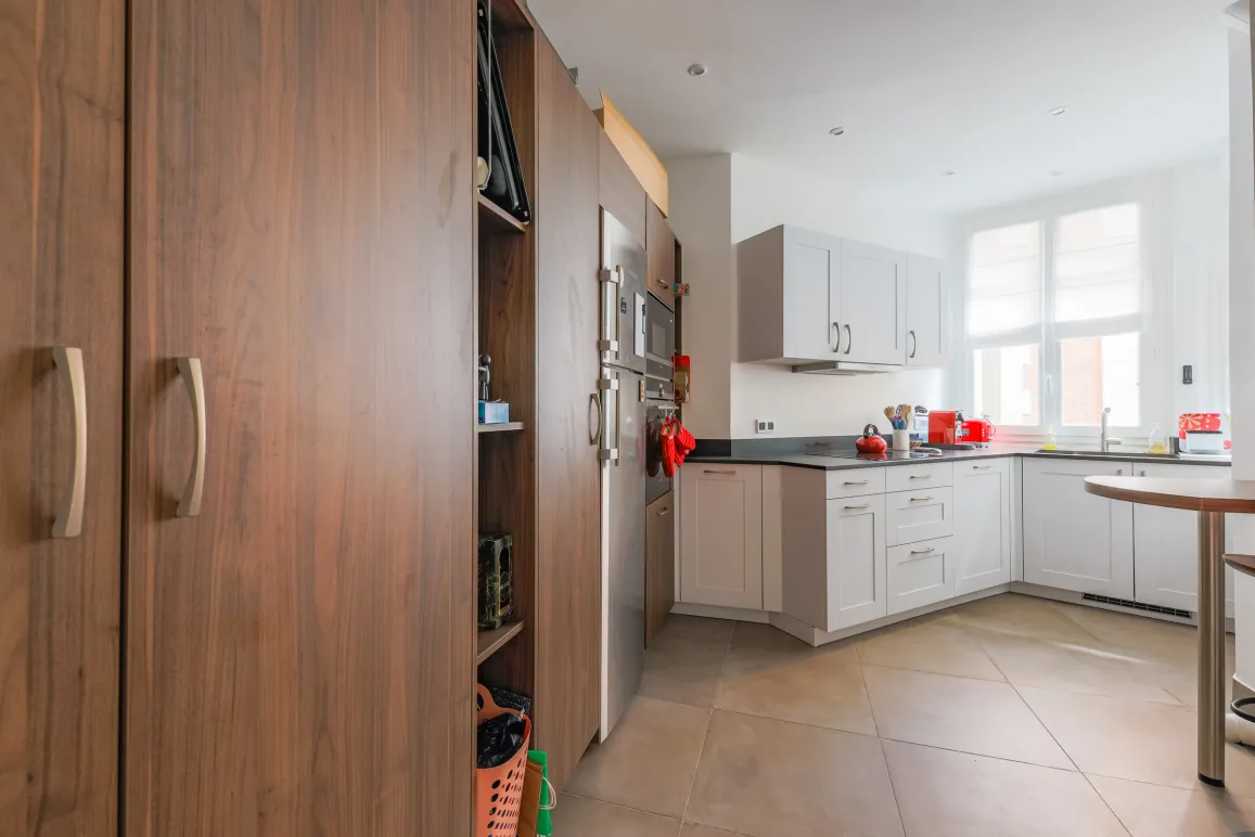 Cuisine moderne et lumineuse avec boiseries élégantes, électroménager inox intégré et finitions haut de gamme. Idéal pour propriété de luxe.